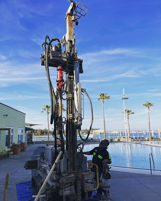 A rig working alongside a waterfront pool deck, a crew member at the controls