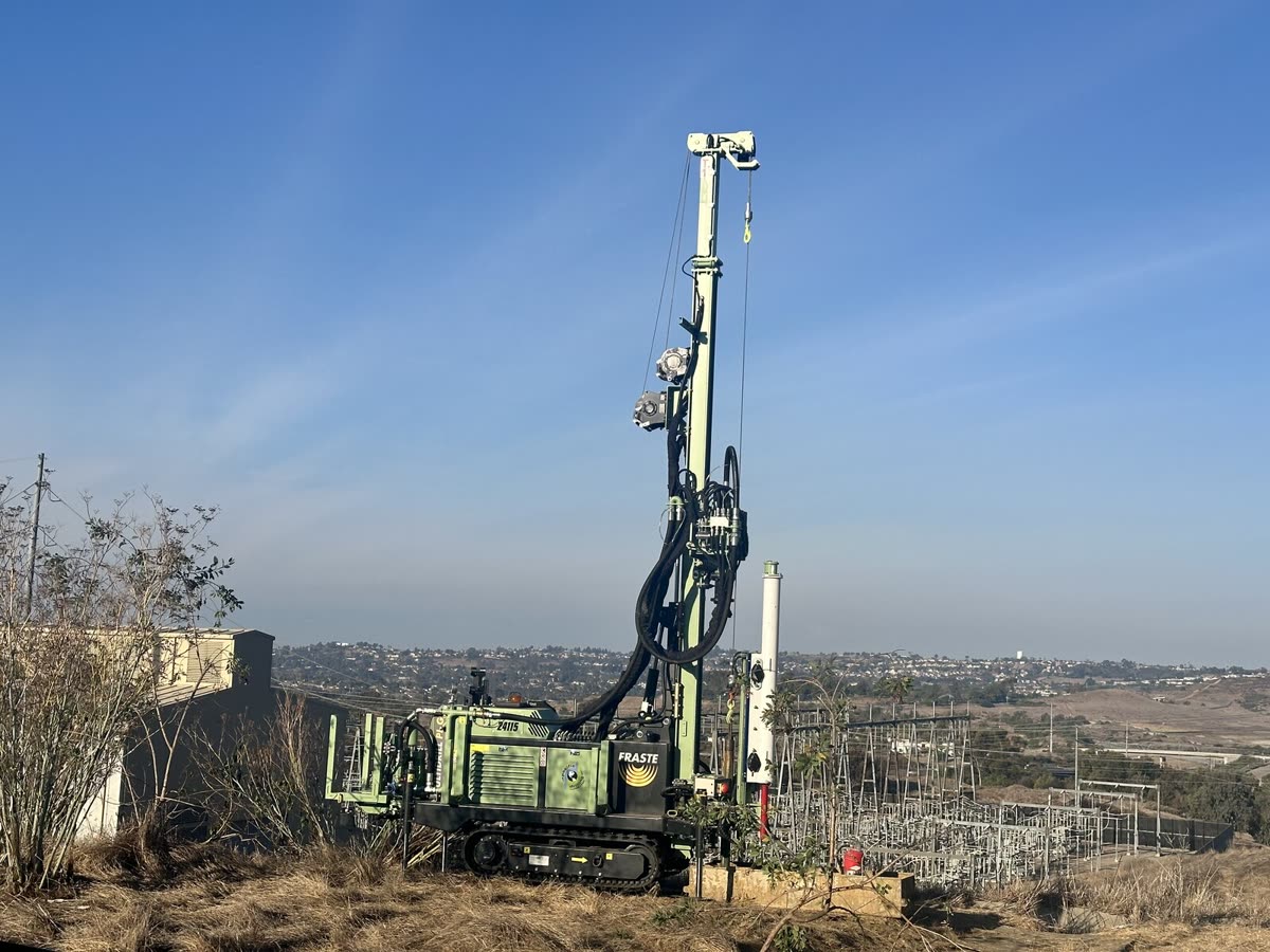 The Fraste Mantis MultiDrill rig working on a bluff above a coastal valley.